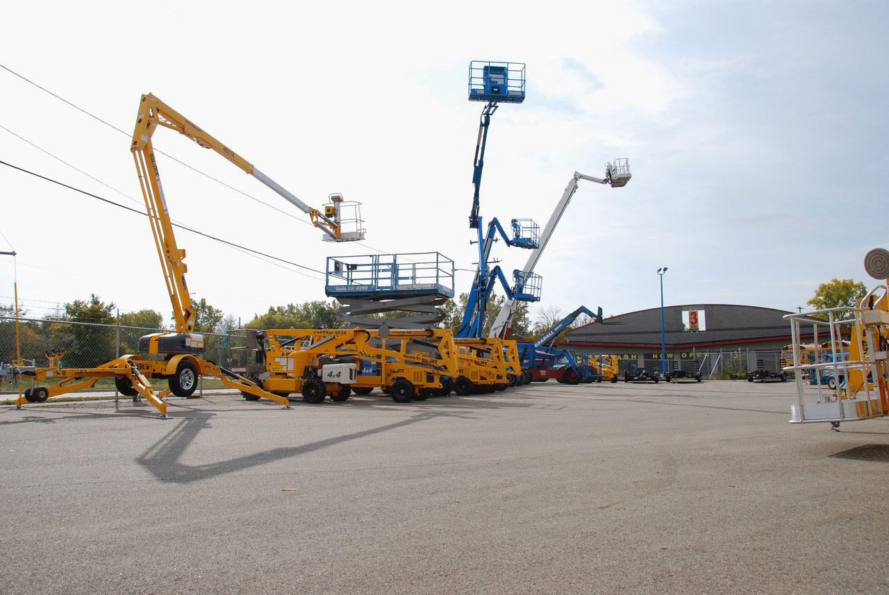 Multiple boom lifts outside