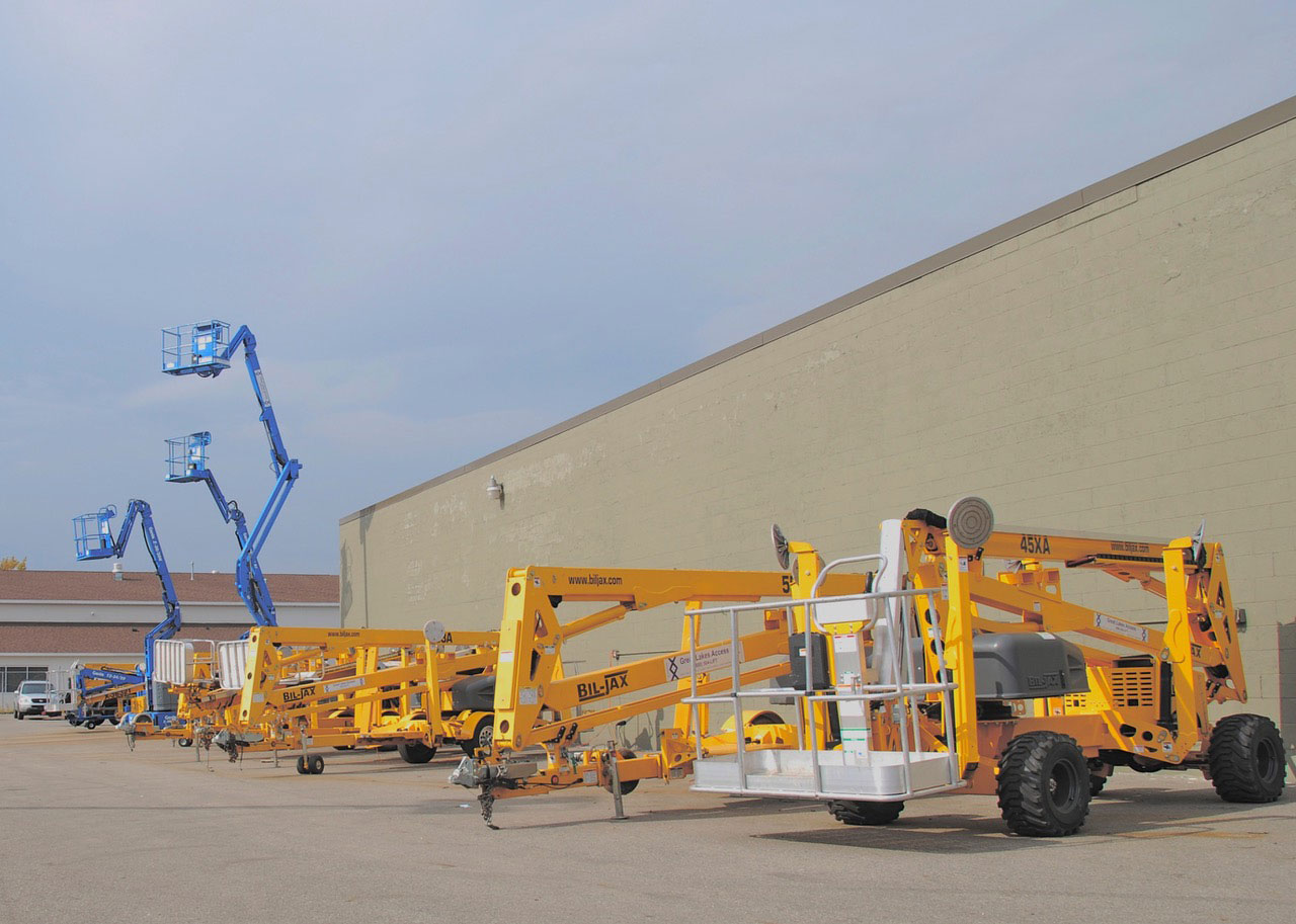 Multiple boom lifts outside