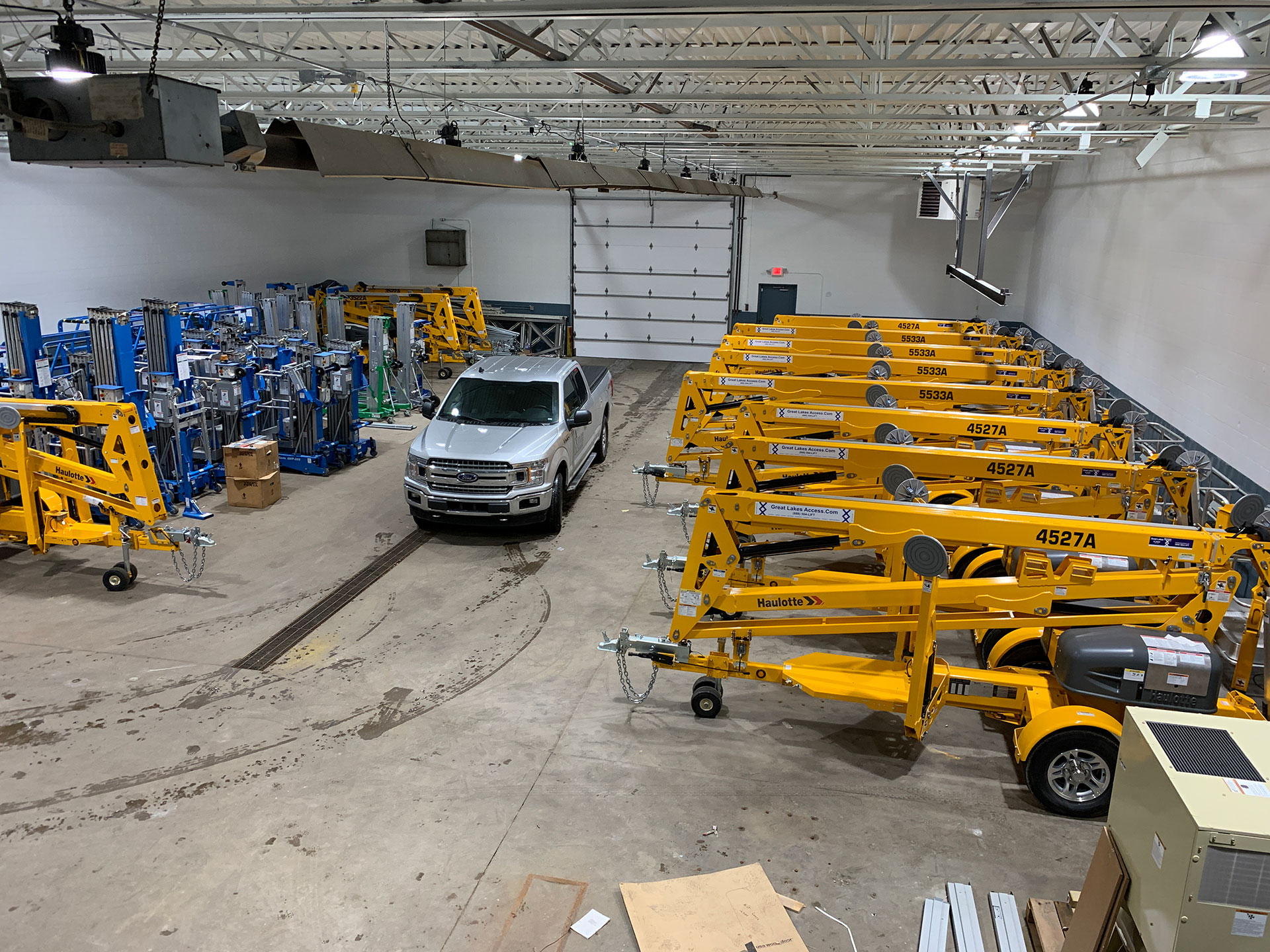 Rental equipment and truck inside garage